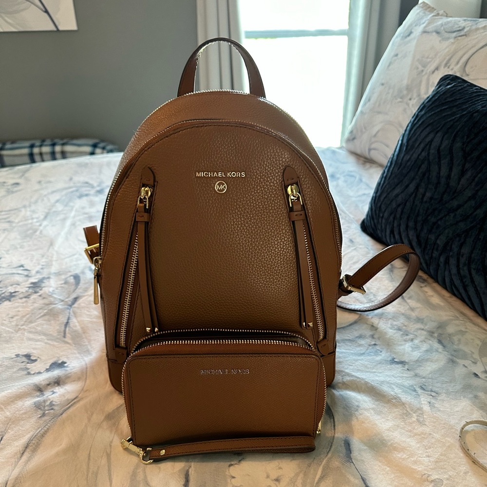 Michael Kors Backpack with matching wallet.  Barely used.  Excellent condition.